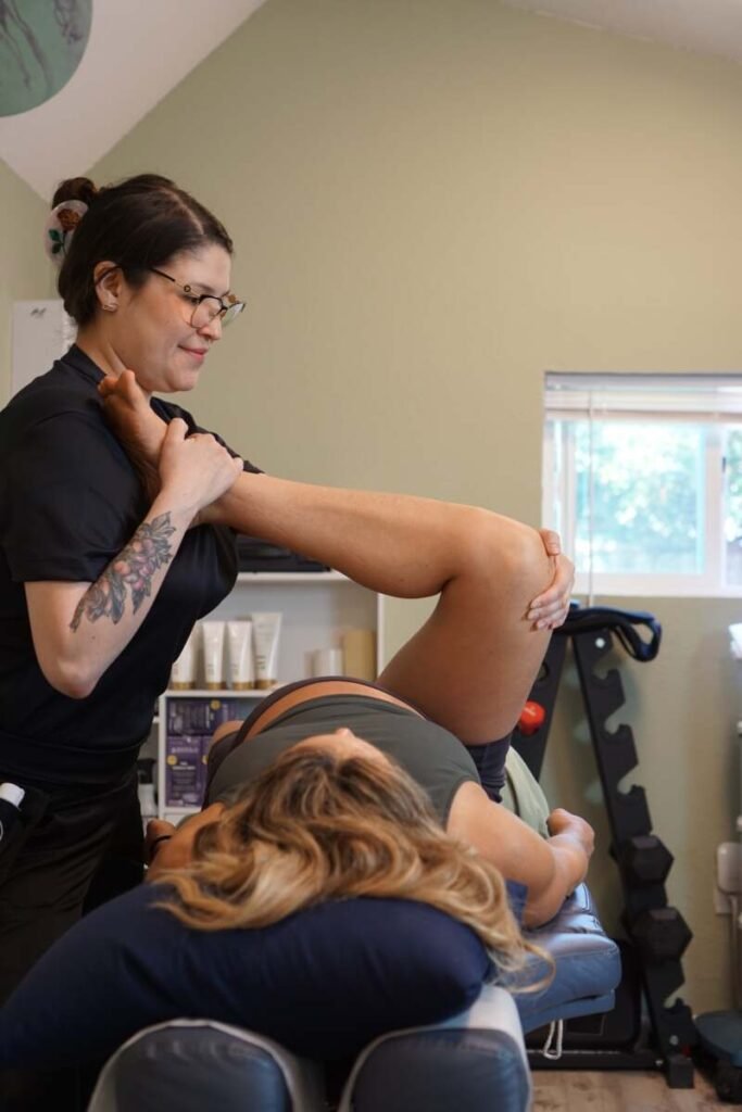 Flexologist guiding an assisted hip and hamstring stretch for improved mobility at The ChiropractOrr
