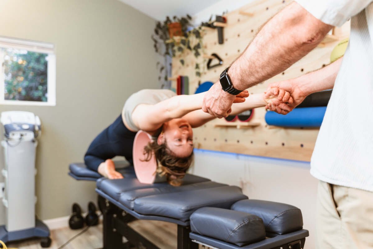 Assisted stretching with pilates wheel